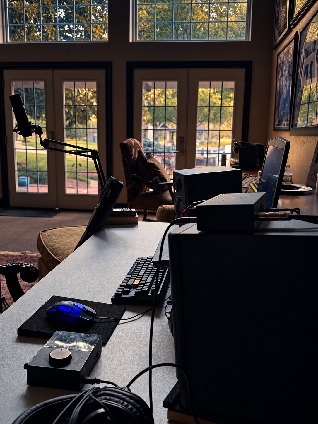 OUTONSPACE Studios desk and recording setup facing the tall room windows