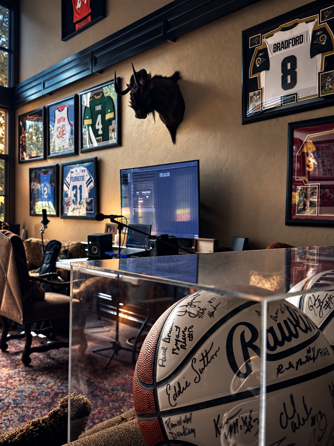 Signed basketball displayed beside the OUTONSPACE Studios workstation